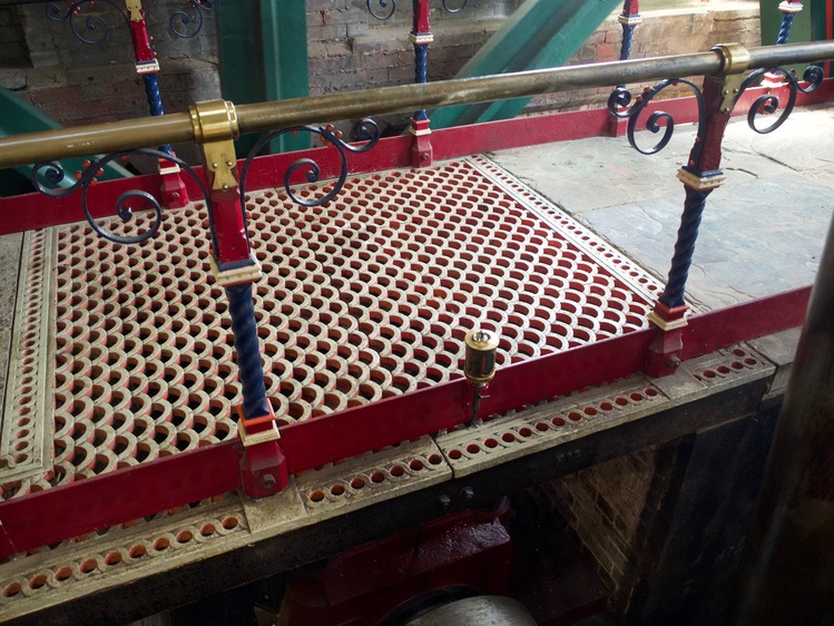 A floor with a tiny half-circle pattern adorned in red and cream.